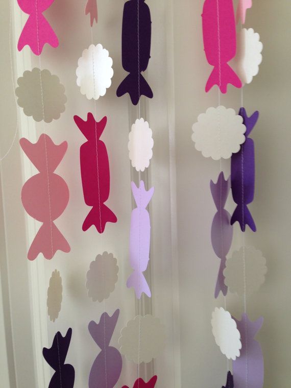 paper cut out animals and clouds hanging from the ceiling in front of a door window