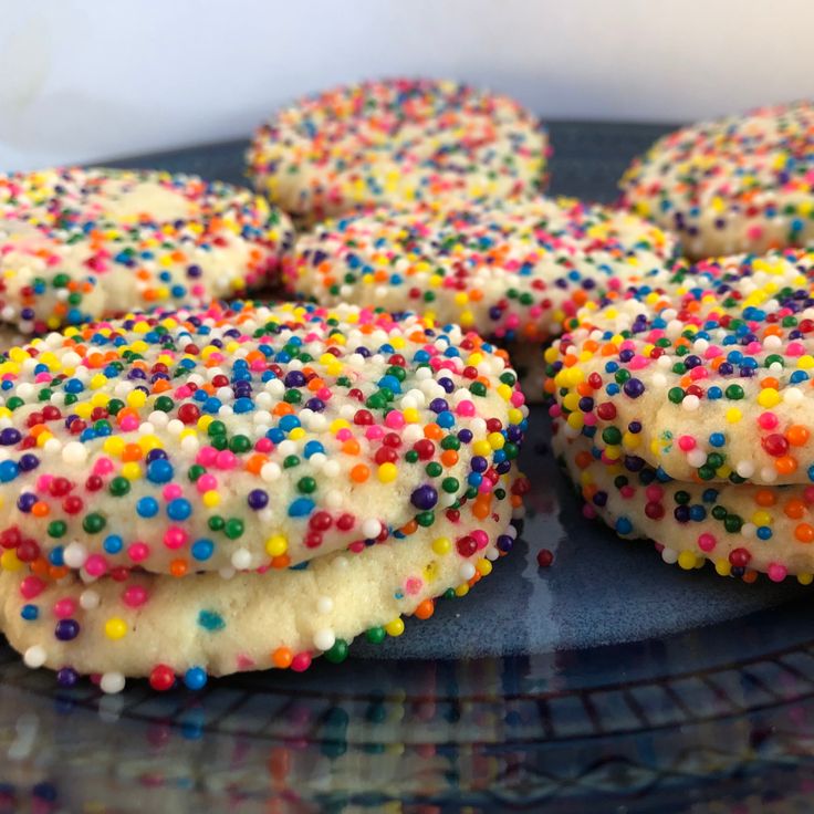 sprinkle covered donuts on a plate ready to be eaten