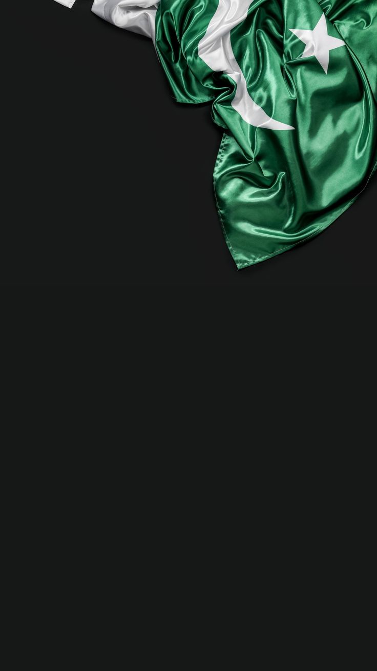 the flag of pakistan is flying in the wind on a black background with space for text