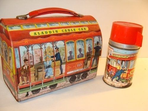 an old fashioned tin box and canister are sitting on the table