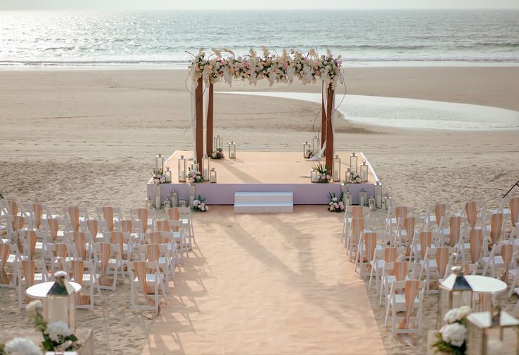 an outdoor wedding set up on the beach