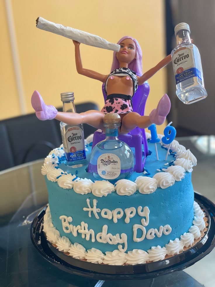 a birthday cake with a barbie doll holding a baseball bat and bottle of vodka on top