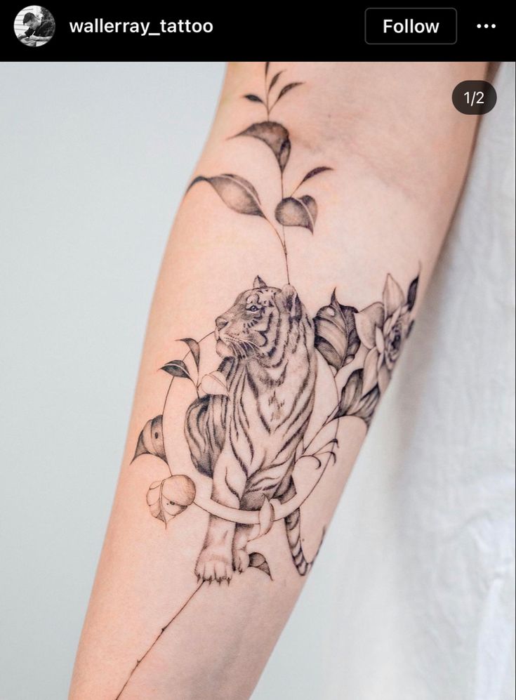 a tiger tattoo on the right arm and shoulder with leaves around it, as well as flowers