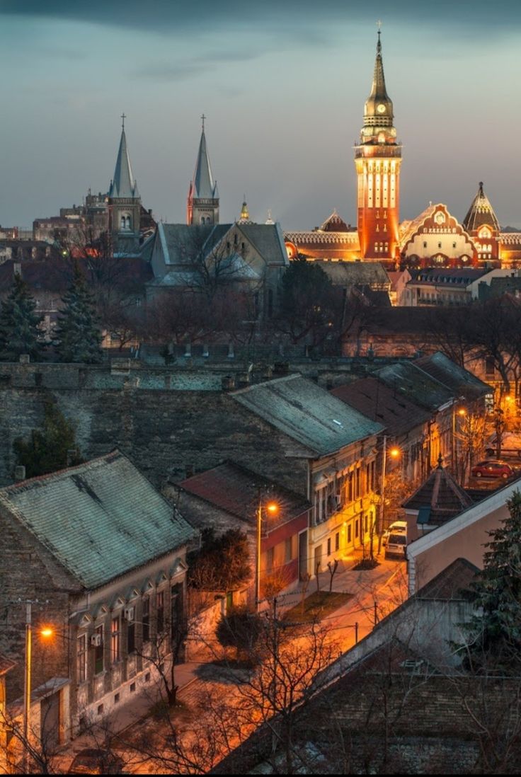 an old town with a clock tower lit up at night