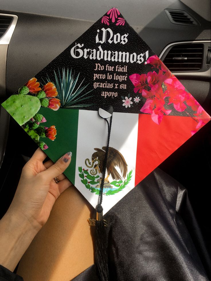 a person holding a graduation cap with the mexican flag on it in their lapel