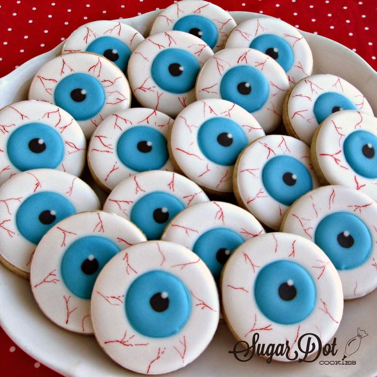 decorated cookies with blue eyes on a white plate