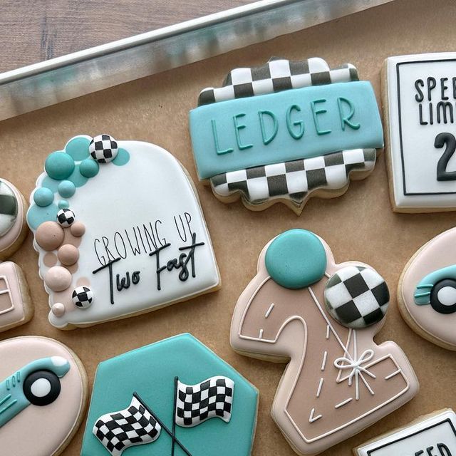 decorated cookies are displayed on a tray