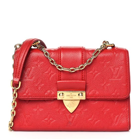 This is an authentic LOUIS VUITTON Empreinte Saint Sulpice BB in Cherry. This beautiful flap style shoulder bag is crafted of red textured leather with a Louis Vuitton monogram embossed all over the bag and red trim. The bag features a brass chain link shoulder straps with a shoulder pad and a cross-over flap with a polished brass lock. This opens to a red microfiber interior with a patch pocket. Red Louis Vuitton Bag, Louis Vuitton Crossbody Bag, Louis Vuitton Crossbody, Louis Vuitton Empreinte, Louis Vuitton Vernis, Embroidered Monogram, Louis Vuitton Shoulder Bag, Wallet Chain, Vuitton Bag