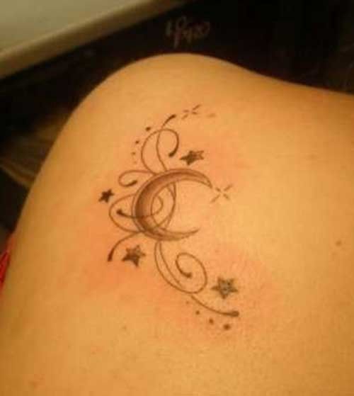 a woman's lower back tattoo with stars and swirls on her left side