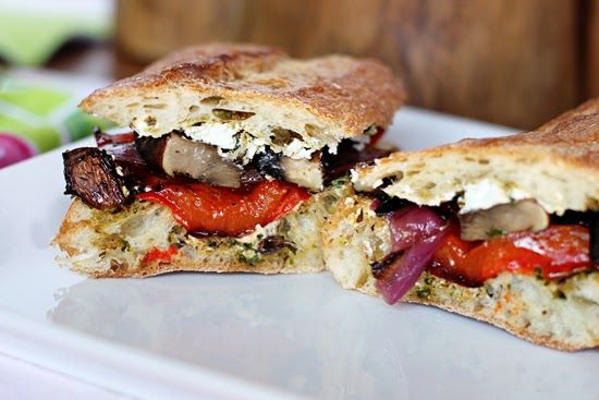 a sandwich cut in half sitting on top of a white plate