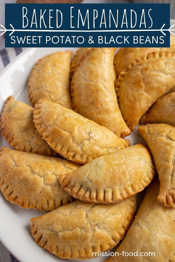 baked empanadas with sweet potato and black beans are on a white plate