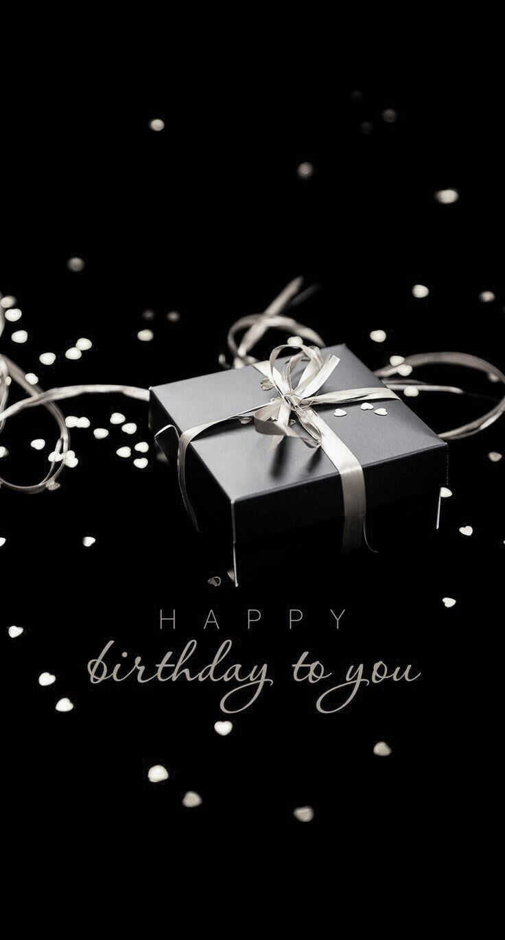 a black gift box with a silver bow on it's ribbon and the words happy birthday to you