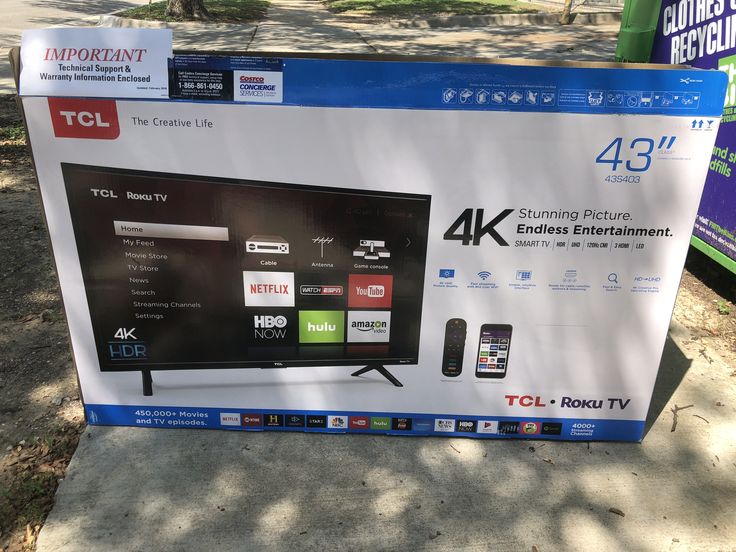 an advertisement for the tcl 4k tv is displayed in front of a tree