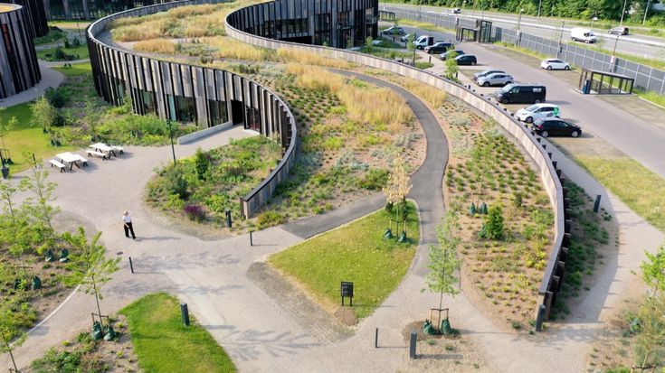 an aerial view of a curved road and parking lot