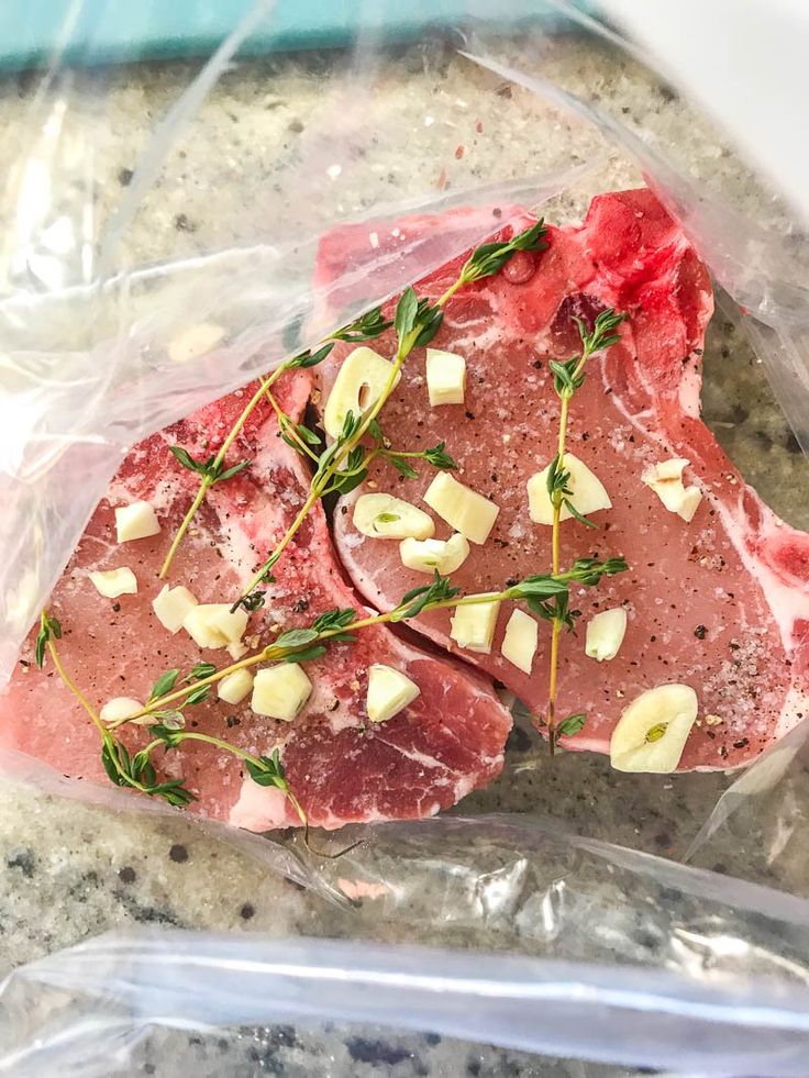 raw meat in a plastic bag sitting on top of a counter