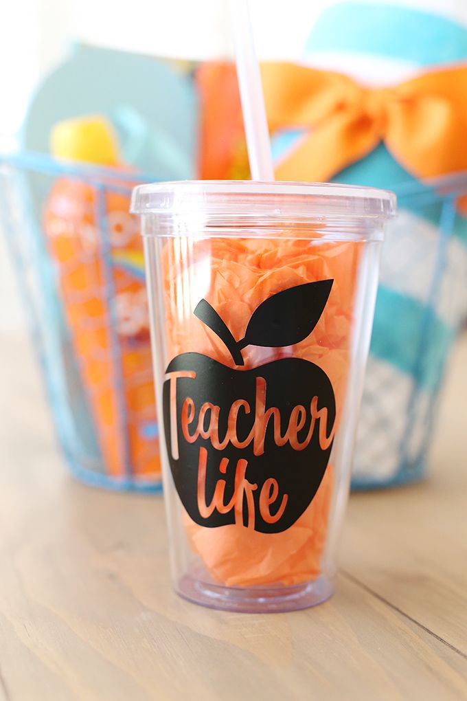 a plastic cup with an apple on the side and teacher's life written on it