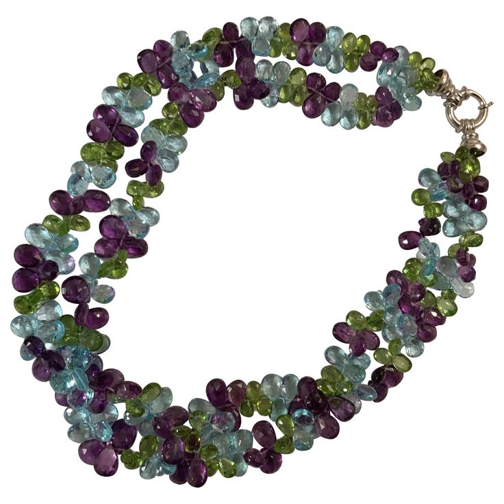 Elegant 2 strand faceted pear shaped Briolette Necklace with Blue Topaz, Peridot and Amethyst finished with 18kt White Gold Clasp. The faceted flat briolettes weigh approximately 520 carats. The Necklace measure 17 inches when twisted loosely. 18kt White Gold Circle Clasp. Please contact me with any inquiries you may have. Best, Christina Addison Jewelry NYC Briolette Necklace, Three Strand Necklace, Peridot Necklace, Gold Bead Necklace, Peridot Stone, Gold Circle, Pink Topaz, Necklace Blue, Hanging Earrings