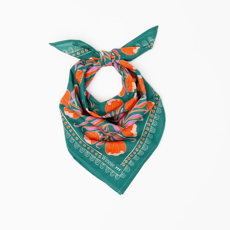 a green scarf with orange flowers on it