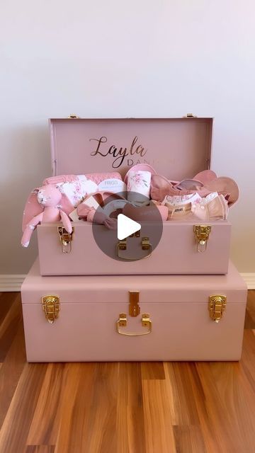 two pink suitcases are stacked on top of each other with personalized items in them