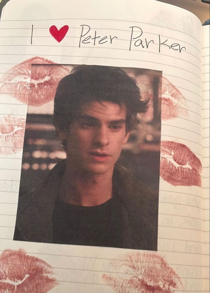 an open notebook with a photo of a man's face and lips on it