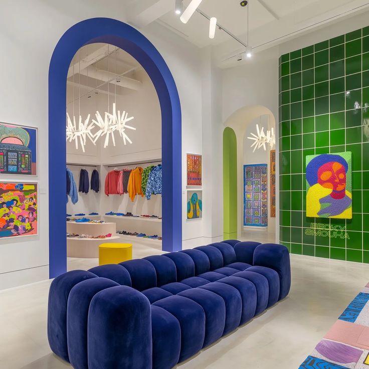 a brightly colored room with art on the walls and colorful rugs in front of it