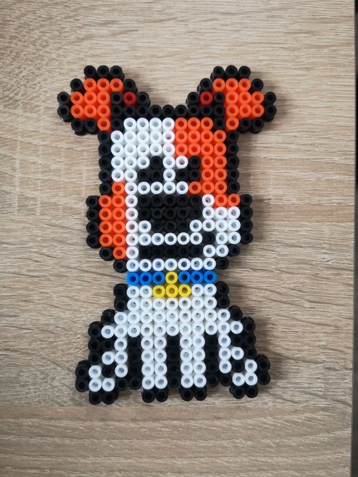 an image of a beaded animal made out of legos on a wooden surface