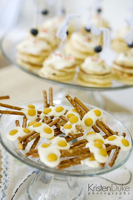 desserts are displayed on glass plates with white frosting