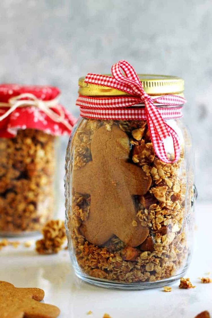 two jars filled with granola and ginger cookies