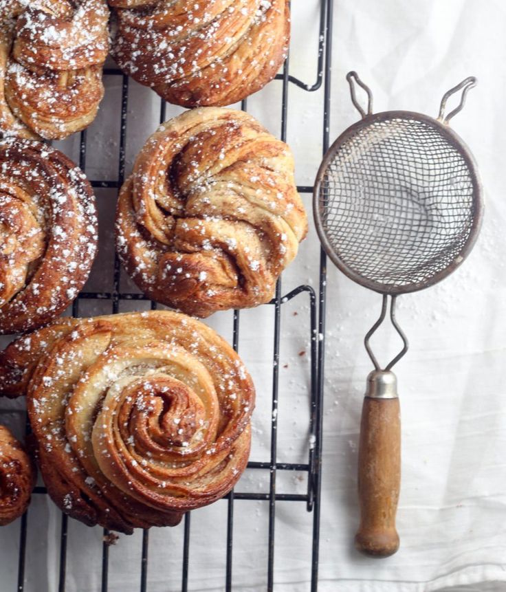 several pastries on a cooling rack next to a grater