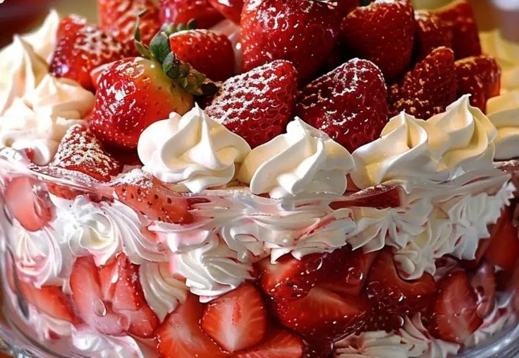 a cake with strawberries and whipped cream on top