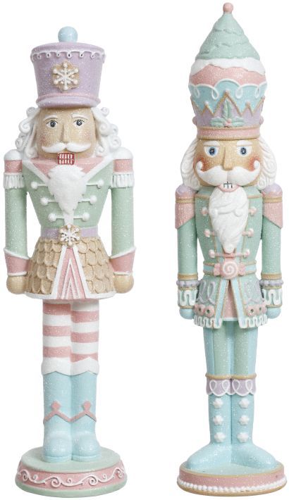 two nutcracker figurines are standing next to each other on a white background