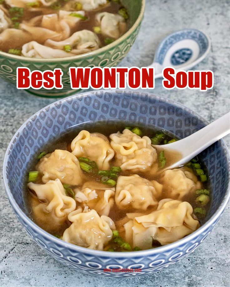 two bowls filled with wonton soup on top of a table