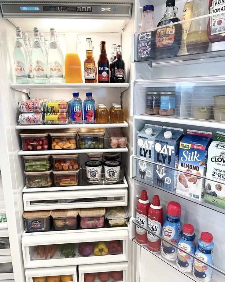 an open refrigerator filled with lots of different types of drinks and food in it's doors