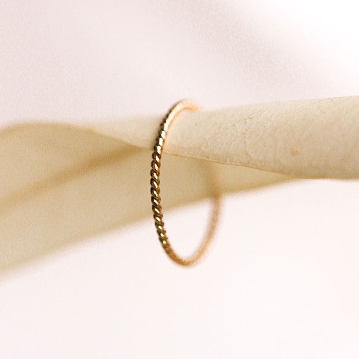 The Barely There Twist is a sweet, delicate, twisted band for the one who is all about texture. This ring is the loveliest solid gold rope you ever did see, and will effortlessly add a textured contrast to your ring stack. The Barely There Twist is also great for rocking the minimalistic look and can be worn by itself. Style it either way, but this classic beauty is a must have for your jewelry collection! Minimalist Twisted Yellow Gold Jewelry, Yellow Gold Twisted Stackable Jewelry, Minimalist Twisted Yellow Gold Ring, Minimalist Twisted Gold Jewelry, Everyday Twisted Yellow Gold Jewelry, Adjustable Twisted Yellow Gold Rings, Twisted Yellow Gold Jewelry For Everyday, Dainty Twisted Yellow Gold Jewelry, Solid Gold Band