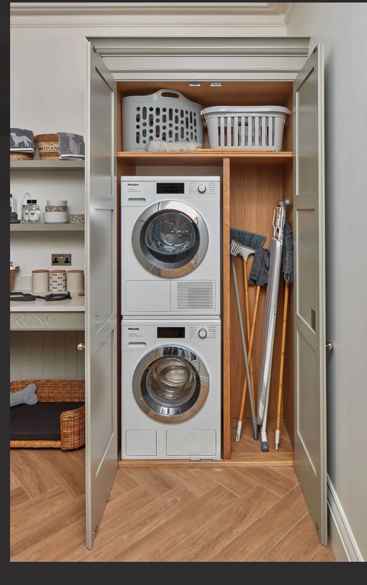 a washer and dryer sitting in a closet next to each other on the floor