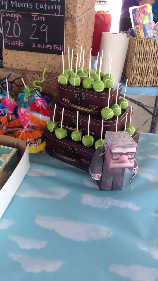 a table topped with lots of cakes and candies on top of wooden skewers