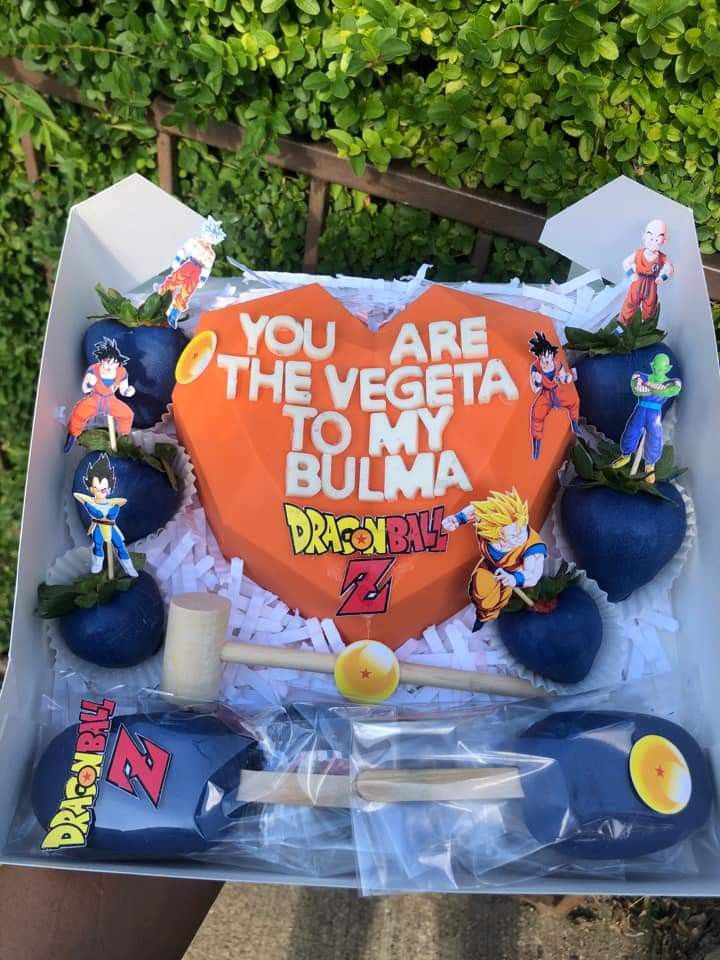 a birthday cake in the shape of a heart with cartoon characters and words on it