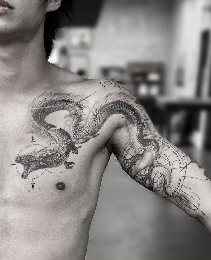 a man with a dragon tattoo on his chest and arm is looking at the camera