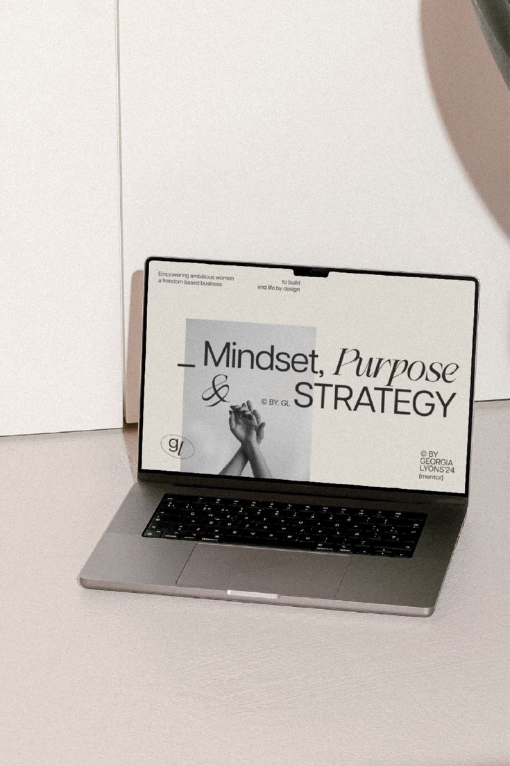 an open laptop computer sitting on top of a white desk next to a lamp and plant