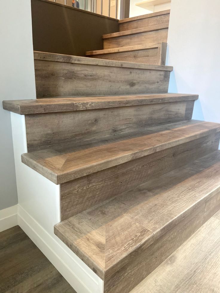 some wooden stairs in a house with white walls