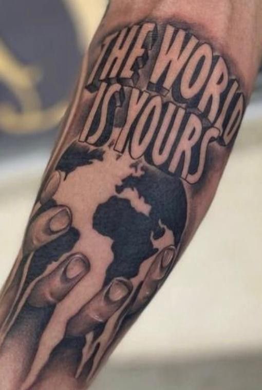 a man's arm with the words world is yours on it and an earth globe