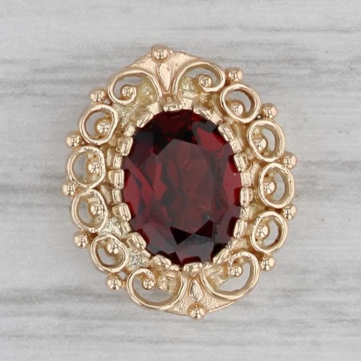 Gemstone Information: - Natural Garnet - Carats - 1.40ct  Cut - Oval Color - Dark Red Metal: 14k Yellow Gold Weight: 2.5 Grams  Stamps: 14k RGVS Measurements: 14.4 x 12.2 mm Each opening will accommodate up to a 2.2 mm chain. Each piece is thoroughly examined and refinished as needed by our professional jewelers, graded by our in-house GIA (Gemological Institute of America) Graduate Gemologist, and inspected for quality before being carefully packaged and promptly shipped. [SKU: B36419] phd Slide Bracelet Charms, Slide Bracelet, Garnet, Jewelry Bracelets, Charm Bracelet, Yellow Gold, Yellow, Accessory Gift, Display Homes