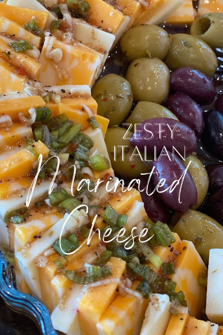 an assortment of cheeses and olives on a platter with the words zesty italian marinated cheese