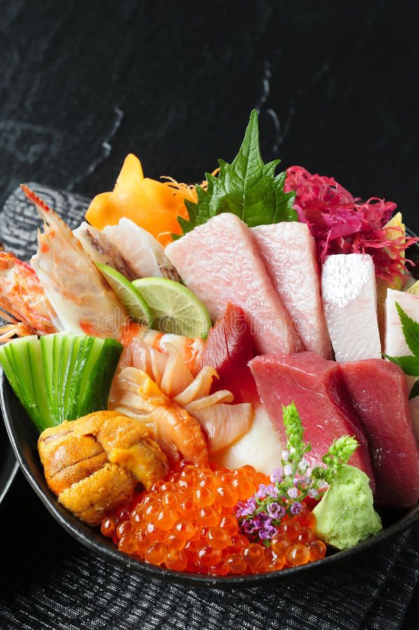 a bowl filled with different types of sushi