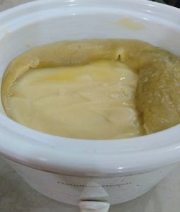 a white blender filled with yellow liquid