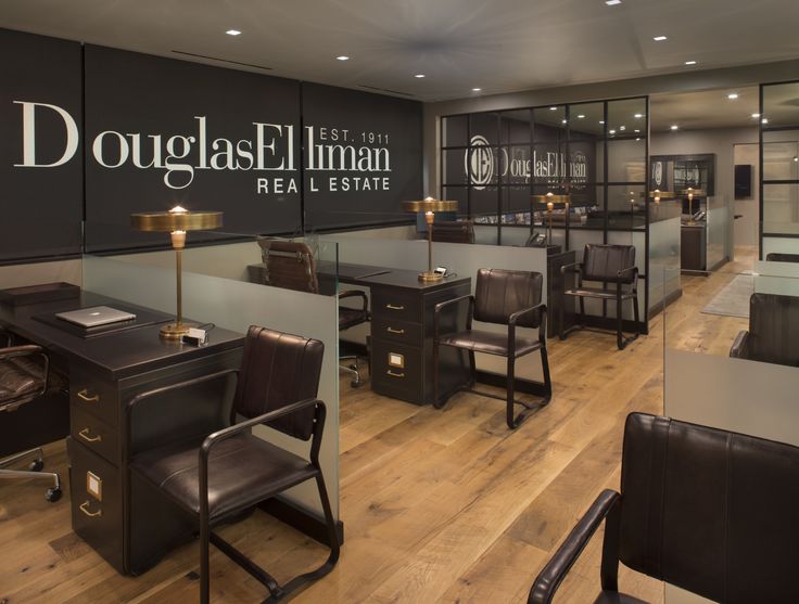 the inside of a restaurant with wooden floors and black signs on the walls that read douglas elliman real estate