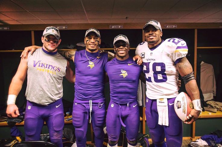 three football players are posing for a photo