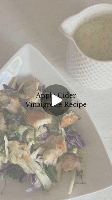 a white plate topped with salad next to a bowl of soup