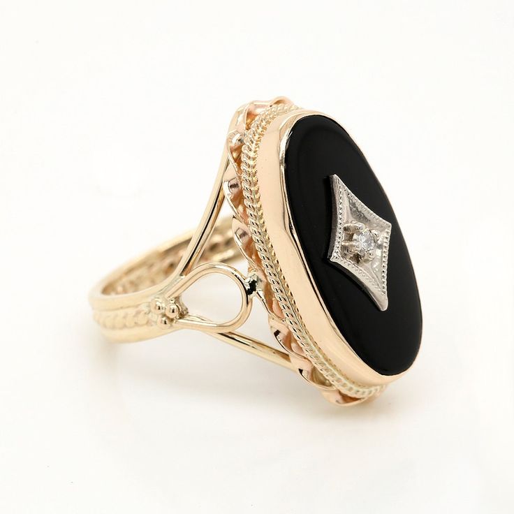 Bold and beautiful vintage style ring made of luscious 14K yellow gold. Features a 14ct oval black onyx (27x13mm) embellished with a gold rhombus (with a bezel set diamond, 0.025ct). Center stone is enclosed in a gorgeous gold twisted wire design and intricate floral shapes. Sizes: 4-8 (smaller and larger sizes are available as custom orders.) PROUDLY MADE FROM SCRATCH IN NEW YORK CITY. Please allow 2-3 weeks to complete this order. SKU: R2016MA Our Pledge: 1. All items to be BRAND NEW and authe Elegant Gemstone Signet Ring For Formal Occasions, Gold Oval Cabochon Diamond Ring For Formal Occasions, Gold Diamond Ring Oval Cabochon For Formal Occasions, Elegant 14k Gold Oval Engraved Ring, Elegant Oval Engraved Ring In 14k Gold, Elegant Oval Engraved 14k Gold Ring, Formal Gold Diamond Ring With Oval Cabochon, Elegant 14k Gold Oval Signet Ring, Antique Rings With Polished Finish For Formal Occasions