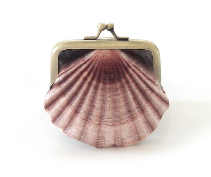 A seashell print features on this original velvet coin purse. Printed velvet front, Scottish linen back and dupion silk lining. Topped with an antiqued brass frame. Perfect for carrying small items, coins, jewellery etc. **Please note this size doesn't fit credit cards** Optional upgrade at checkout for gift box with customised name. + top width is 3 inches, bottom of purse 3.5 inches, height 3 inches + in cm: top width is 7.5cm, bottom of purse 9cm, height 7.5cm + original printed velvet front Mermaid Purse, Antique Brass Frame, Seashell Print, Velvet Purse, Purse Frame, Printed Velvet, Dupion Silk, Shell Jewelry, White Gift Boxes